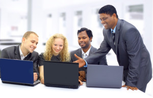 Interracial business team working at laptop in a