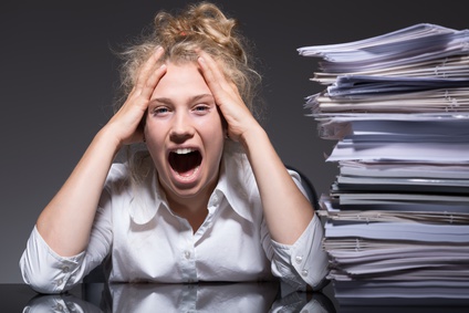 Young woman frustrated and stressed at work